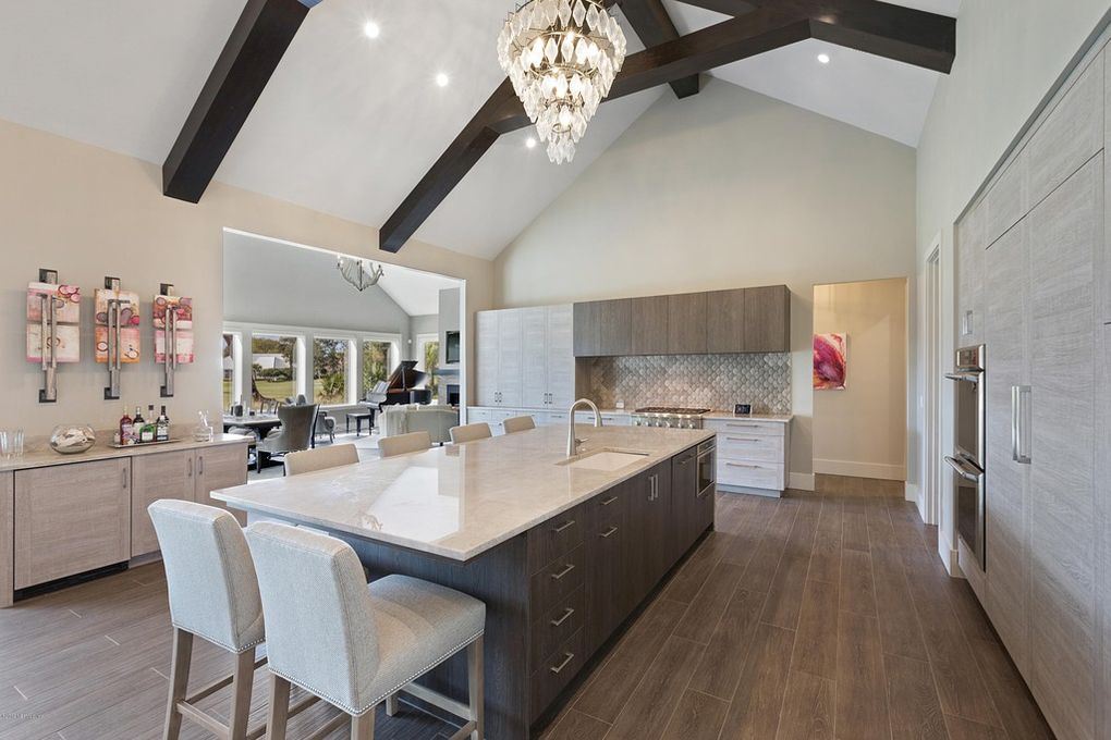 Florida interior design of stunning kitchen with vaulted ceiling and large island.