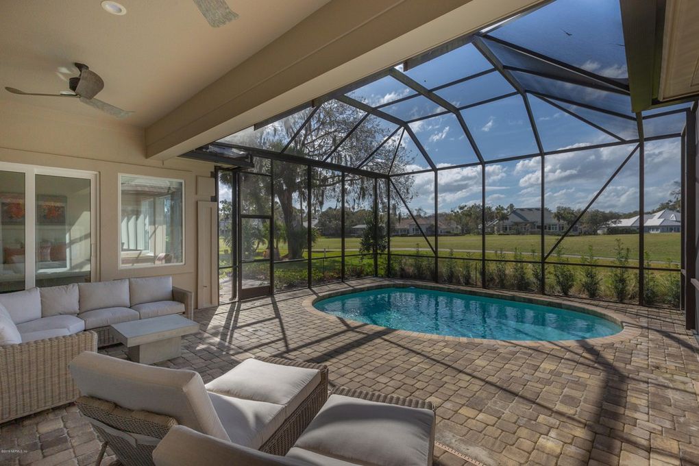 Florida interior design by Charleston Interior Designer, Debby Gomulka, featuring covered pool and outdoor seating space.
