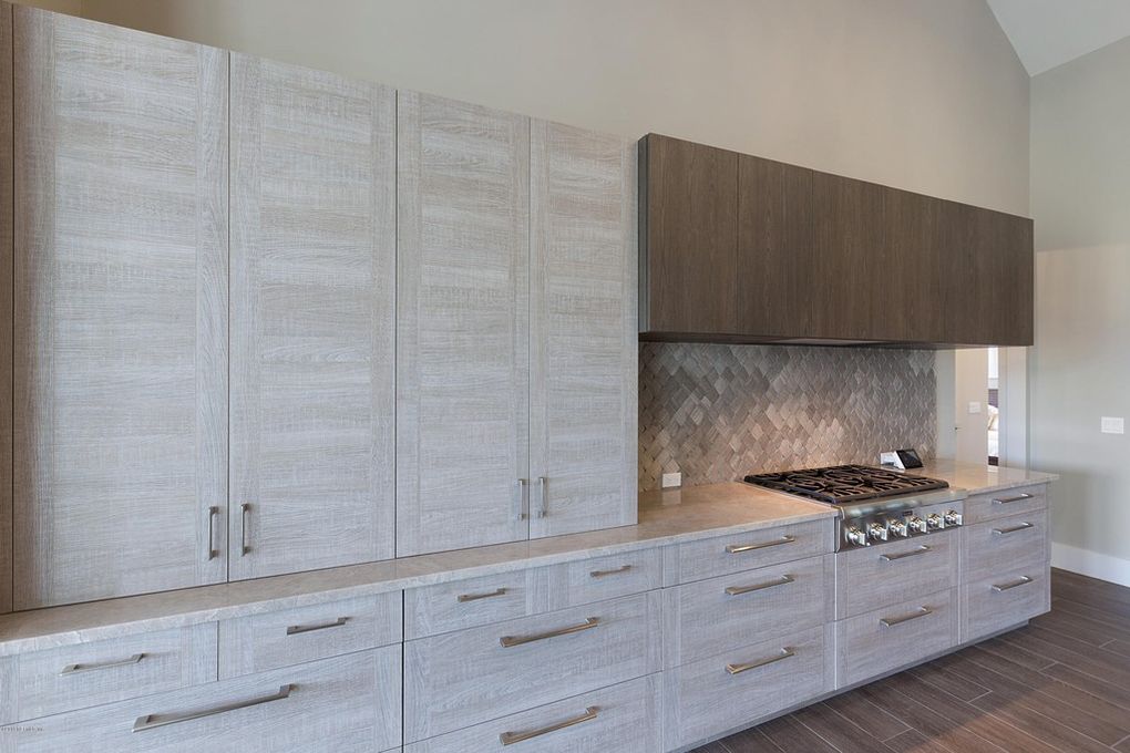 This vacation home in Ponte Vedra Beach includes a white kitchen that's impressive and functional. Get inspired by this Florida interior design