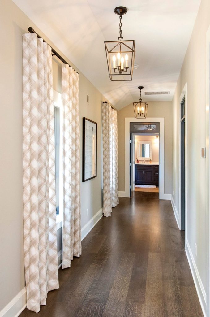 Debby Gomulka brought the mediterranean charm to a recent Charleston interior design project with floor to ceiling curtains, art and light fixtures.