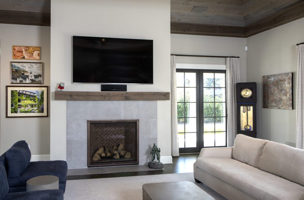 This Charleston interior design includes a feature fireplace styled with antiques and art.