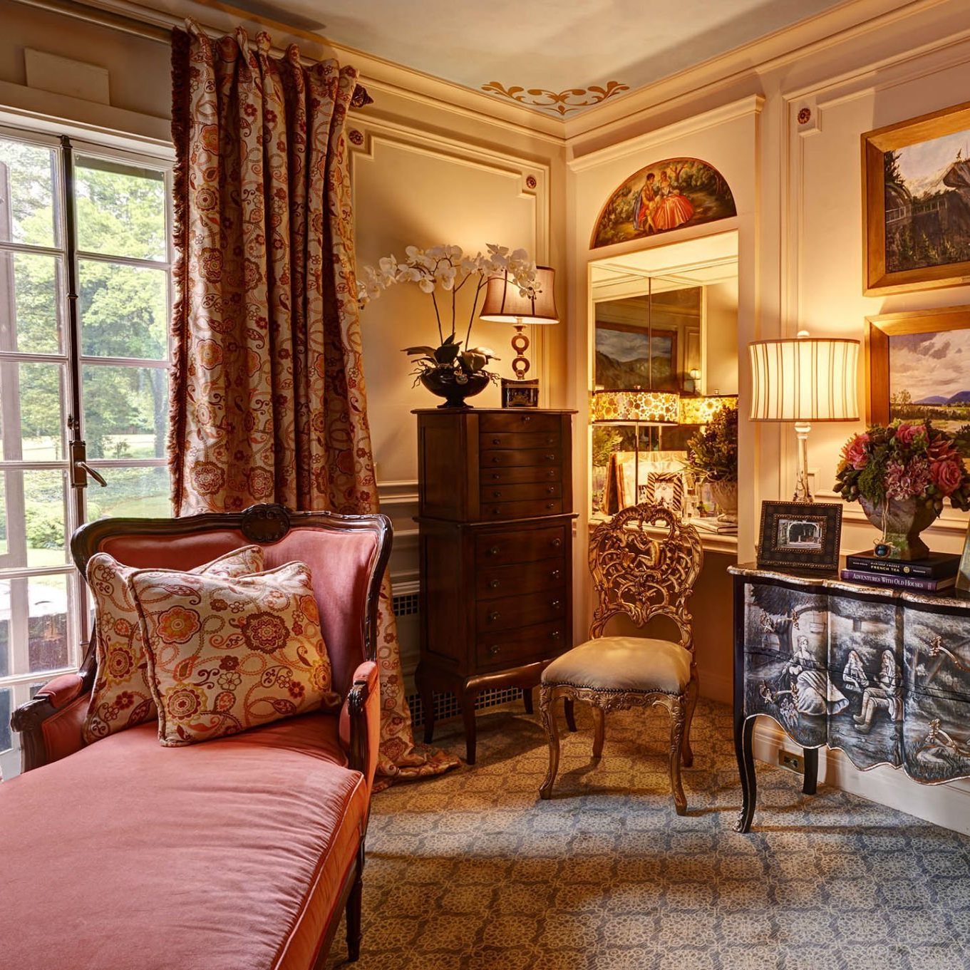 Antique furniture, rich fabrics and warm lighting create a cozy bedroom interior design in North Carolina